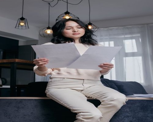 A person reviewing documents calmly in an apartment